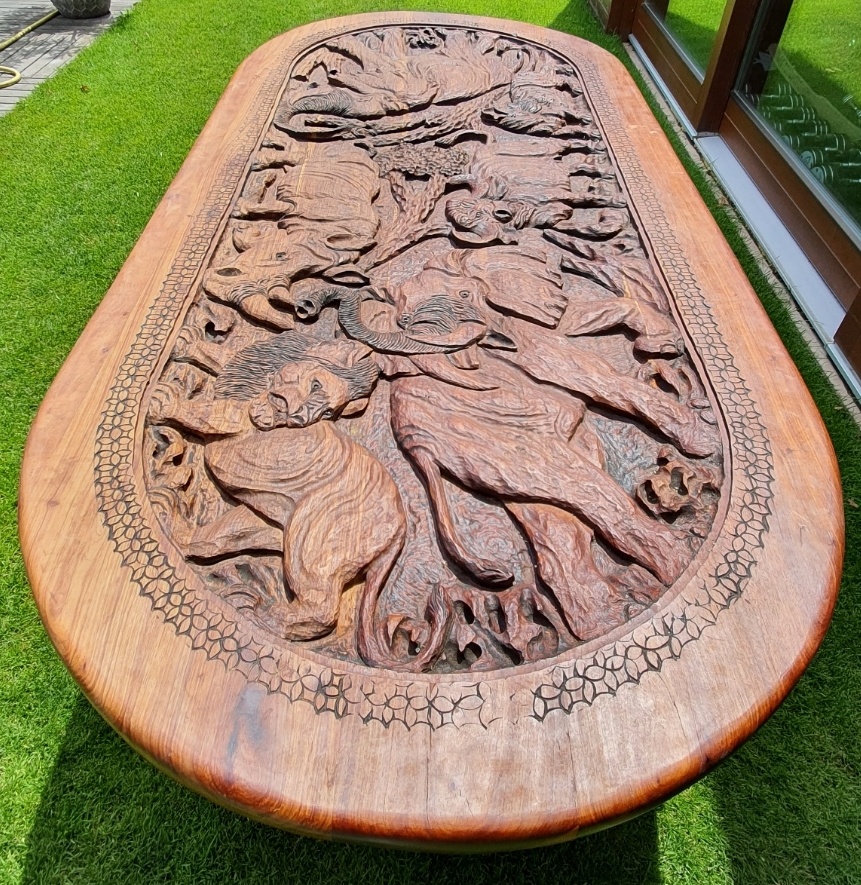 Vyrezávaný kiaat wood interiérový stôl s loveckou tematikou