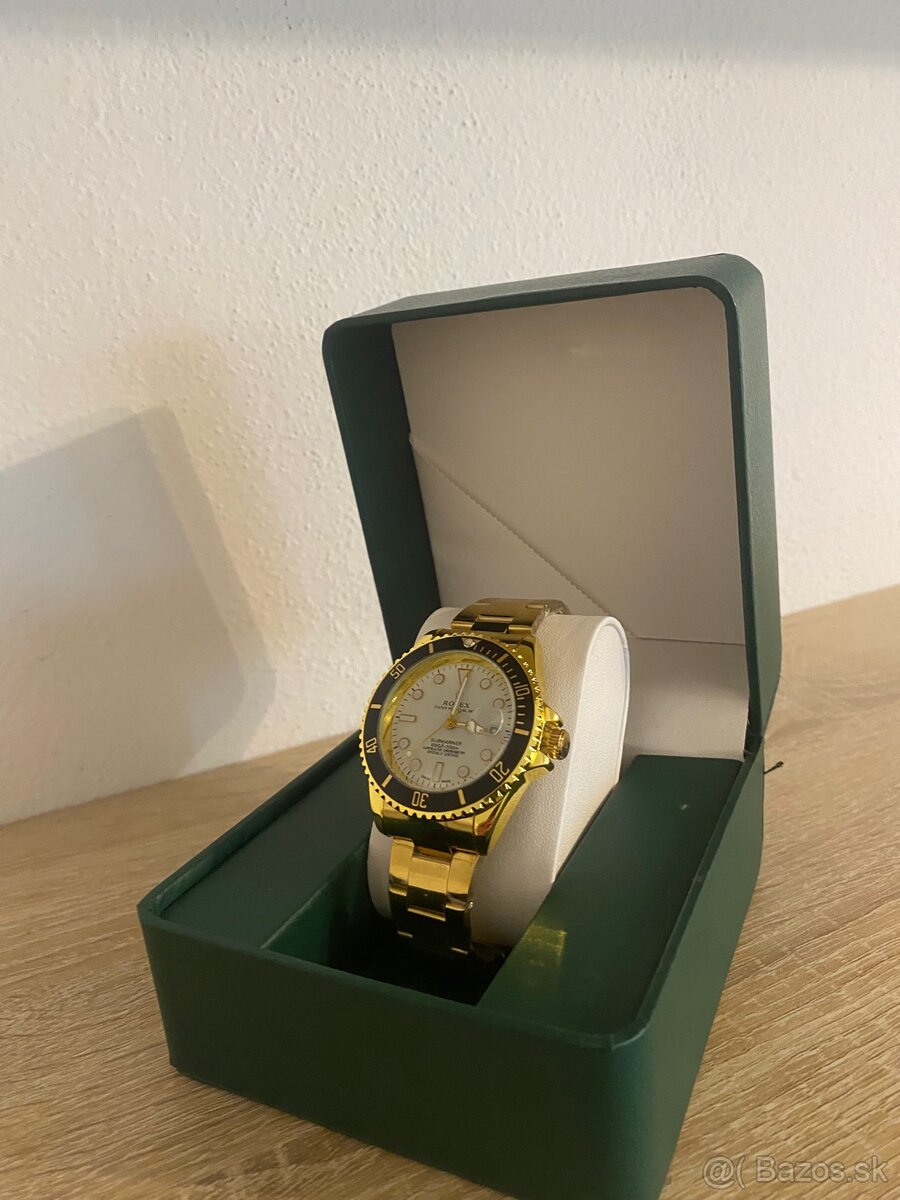 Rolex Submariner - yellow gold, white dial