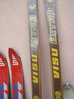 Lyžařská výbava - 9 párů lyží, hůlky, boty - 19