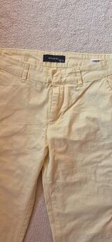 nové maslovožlte nohavice Reserved 36