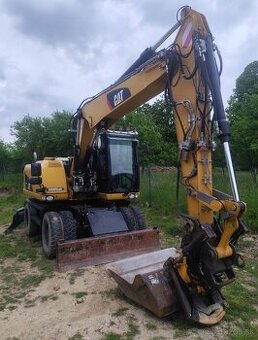 Caterpillar M313D kolesový bager