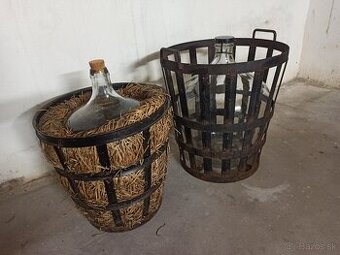 Veľké sklenené demižóny s kovovým košom