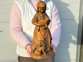 Krásná stará dřevěná socha dívenka držící kočku
