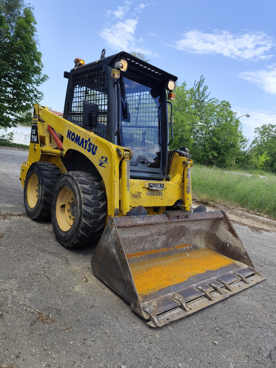 Šmykový nakladač Komatsu SK714. - 2