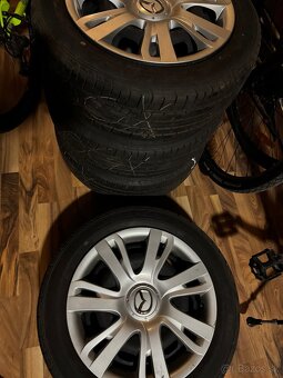 Mazda letne pneumatiky s diskami a puklicami - 7